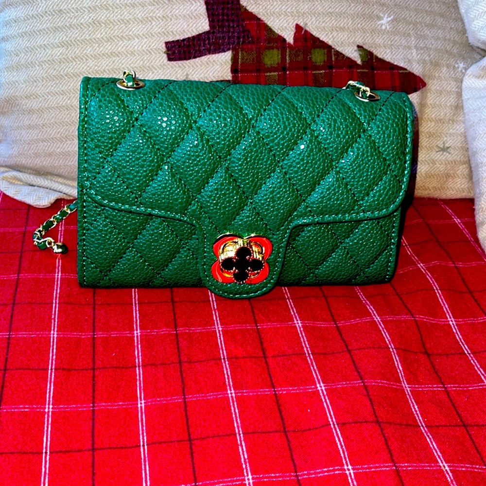 NWT rich green in color small shoulder bag with gold color hardware!